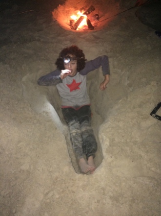 Boy digs giant hole and eats s'mores